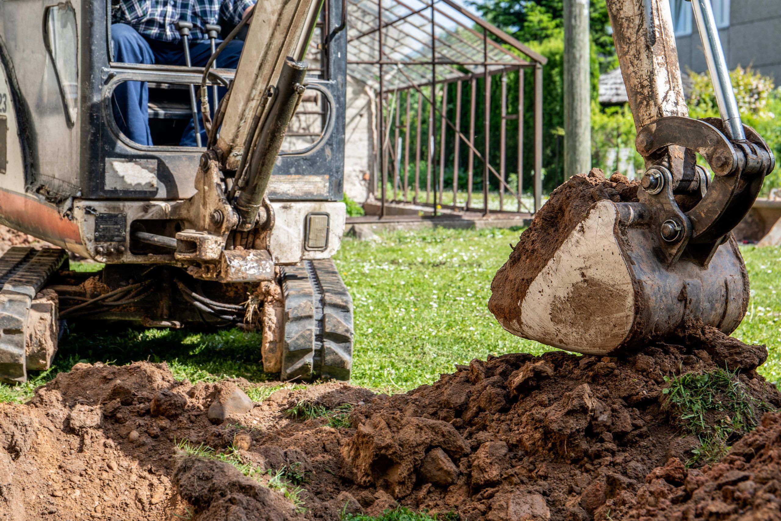 A mini excavator doing garden improvement and landscaping